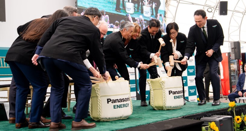 Business and community leaders gather on stage for a traditional Japanese ceremony — Kagami Biraki, or a sake barrel opening — as part of the Grand Opening Ceremony for Panasonic Energy's new EV battery facility in De Soto, KS.