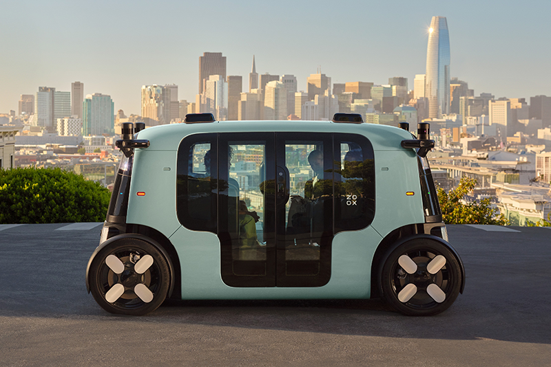 Exterior side view of a Zoox robotaxi carrying 3 passengers